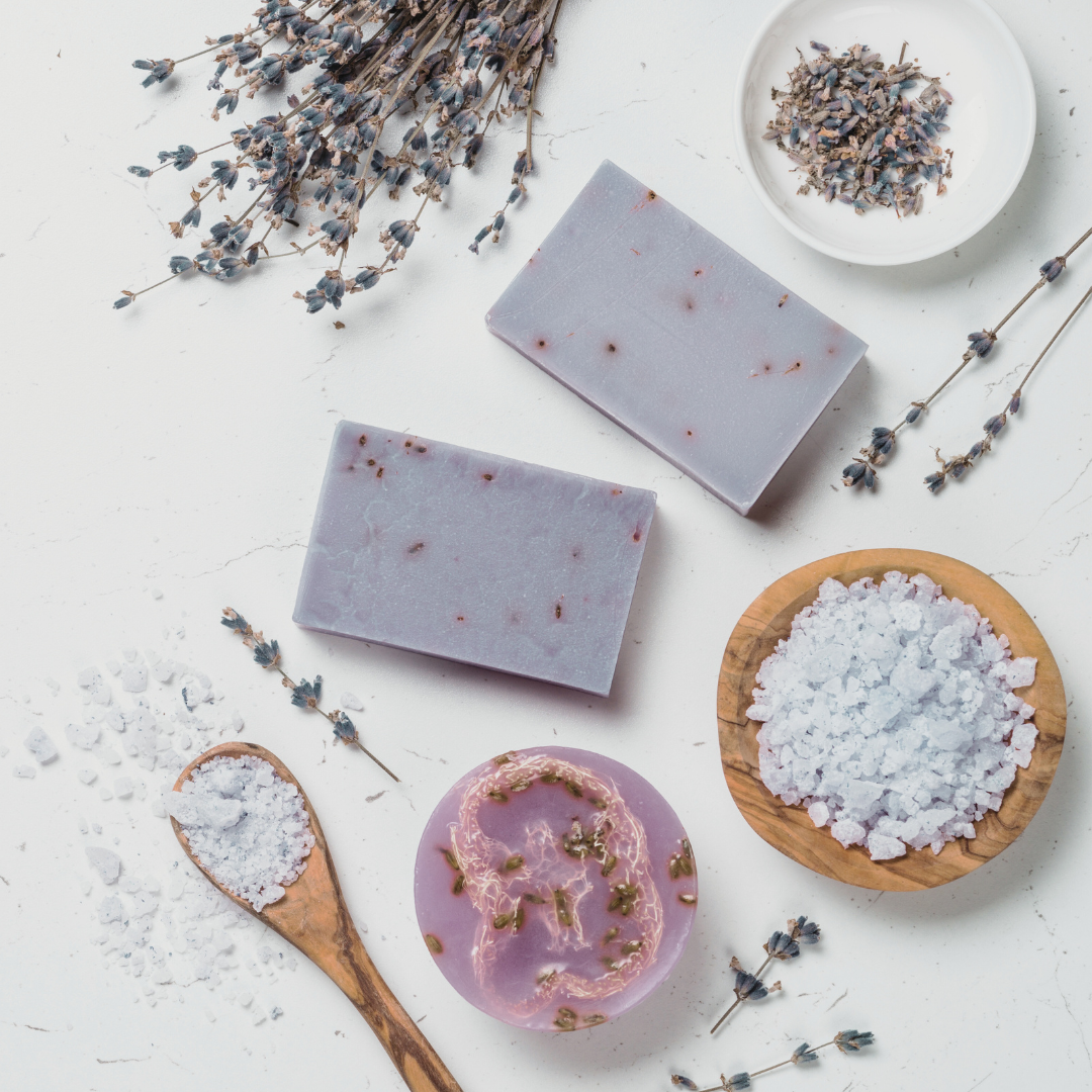 Handmade soaps infused with Lavender 'English', displayed with freshly harvested lavender flowers and leaves. The natural soaps, accented by the aromatic lavender, offer a touch of rustic charm and relaxation.